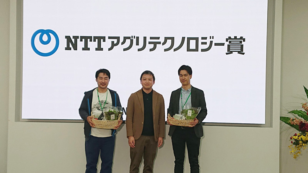 NTTアグリテクノロジー賞の受賞者（写真右・左）と弊社前原取締役